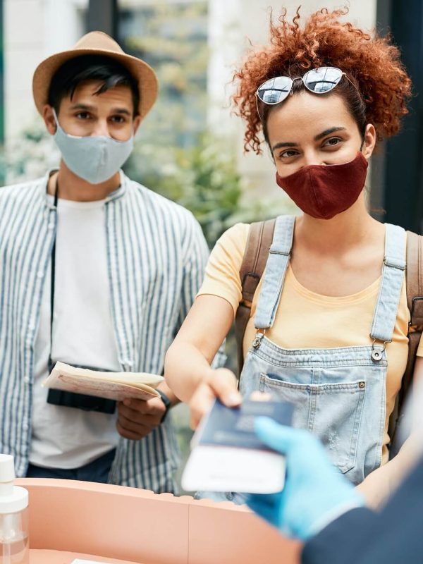 young-traveling-couple-wearing-protective-face-mask-during-check-in-at-hotel-reception-1-1.jpg young-traveling-couple-wearing-protective-face-mask-during-check-in-at-hotel-reception-1-1.jpg